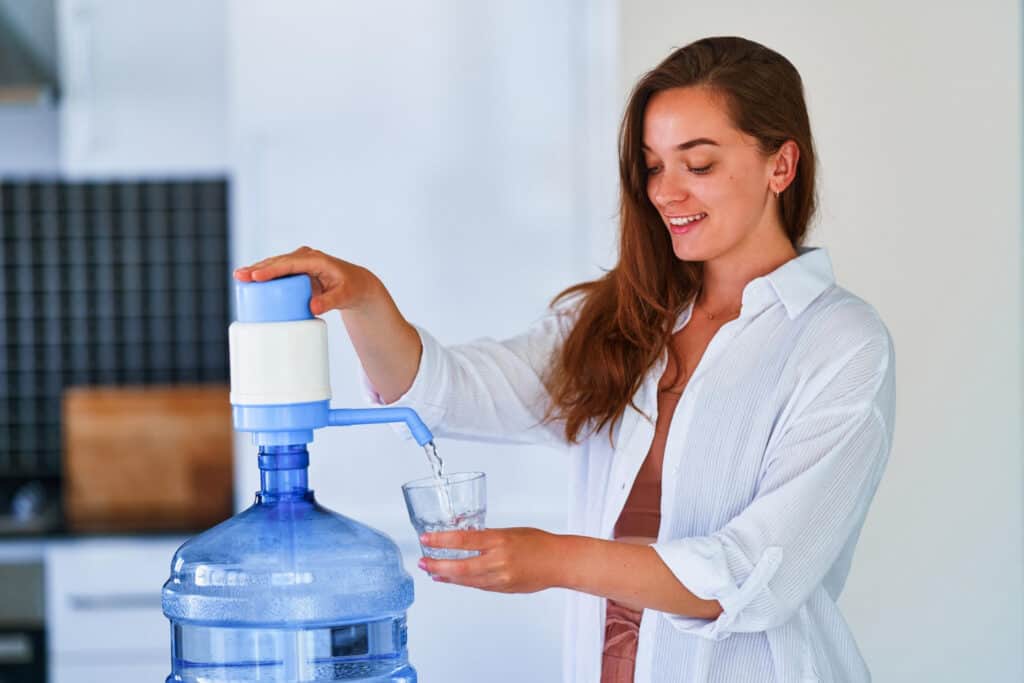 happy woman pouring fresh water